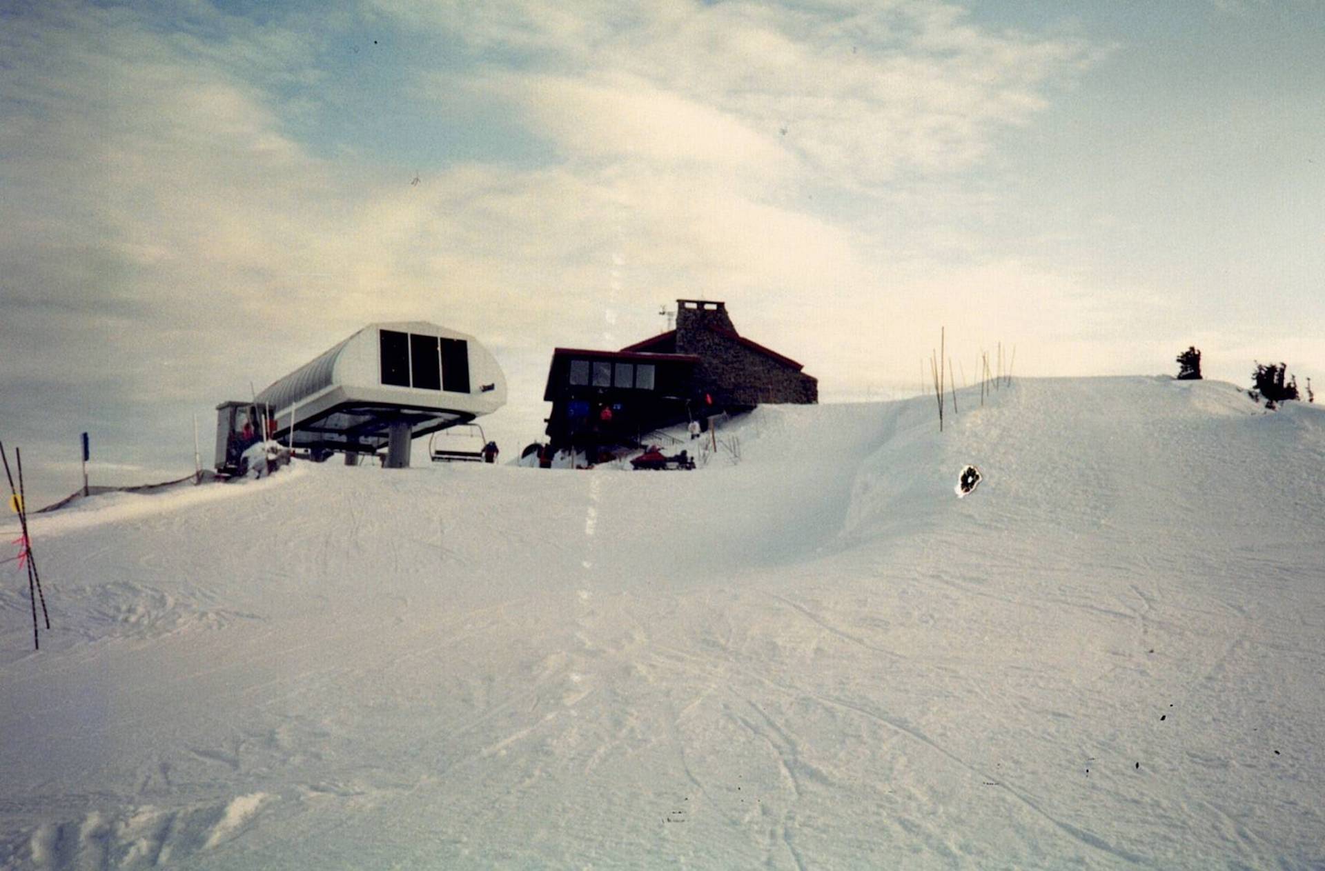 Top of the REX chairlift peering out over the cloud-covered peak