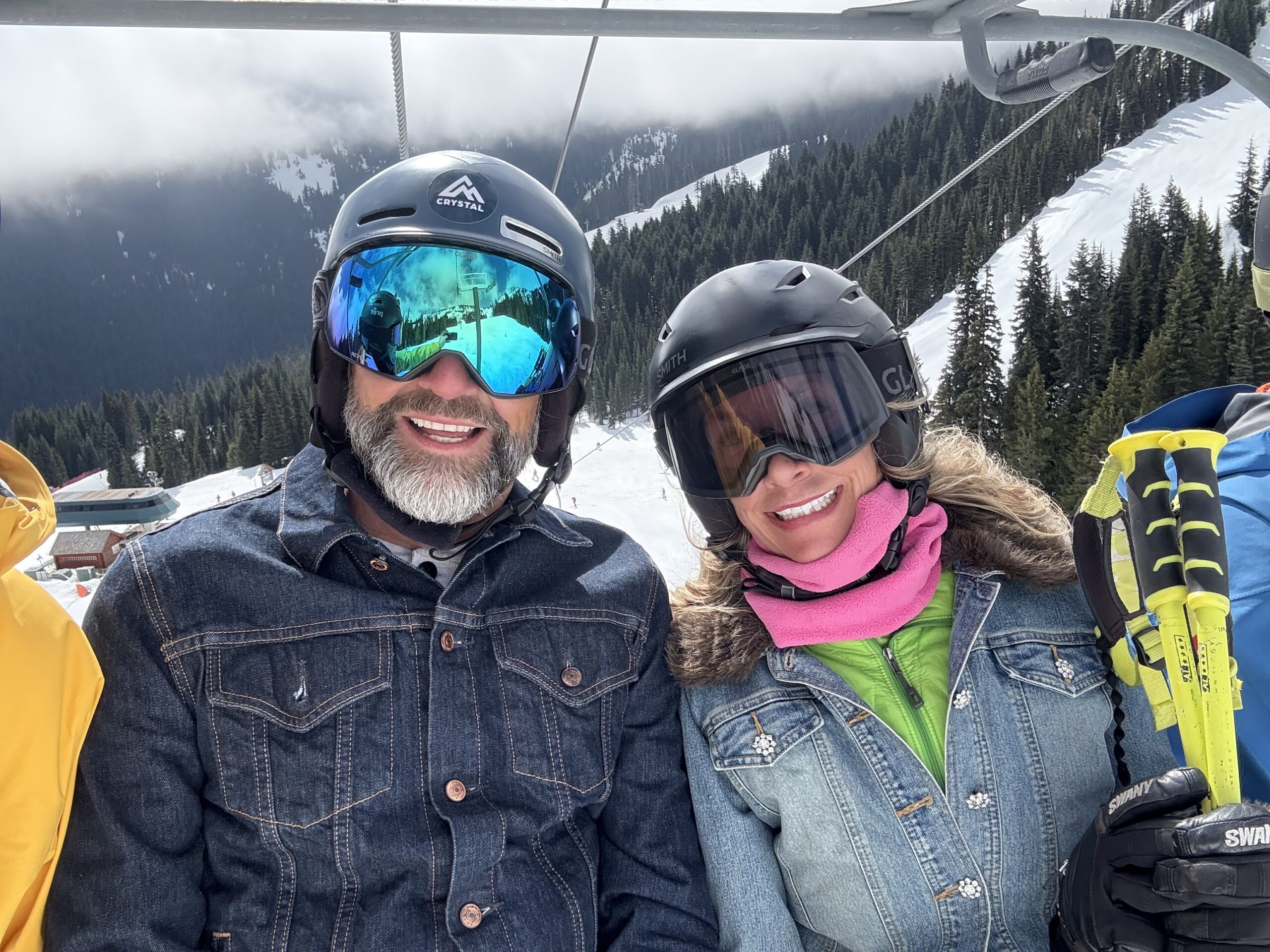 Julie and her two of her friends or family smile on a REX ski chair