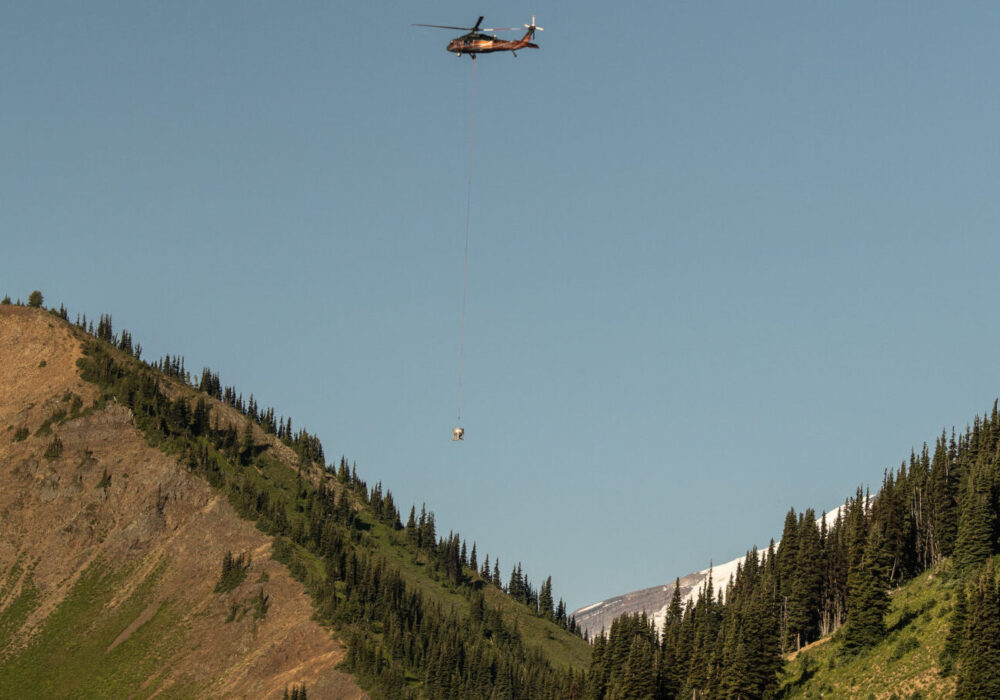 Airborne helicopter with blue sky in the background.