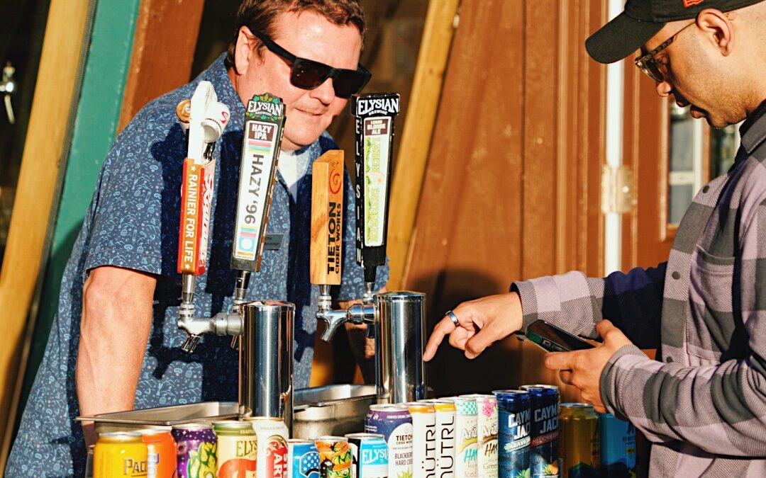 Man serves a guest a beer at Summit Fest.