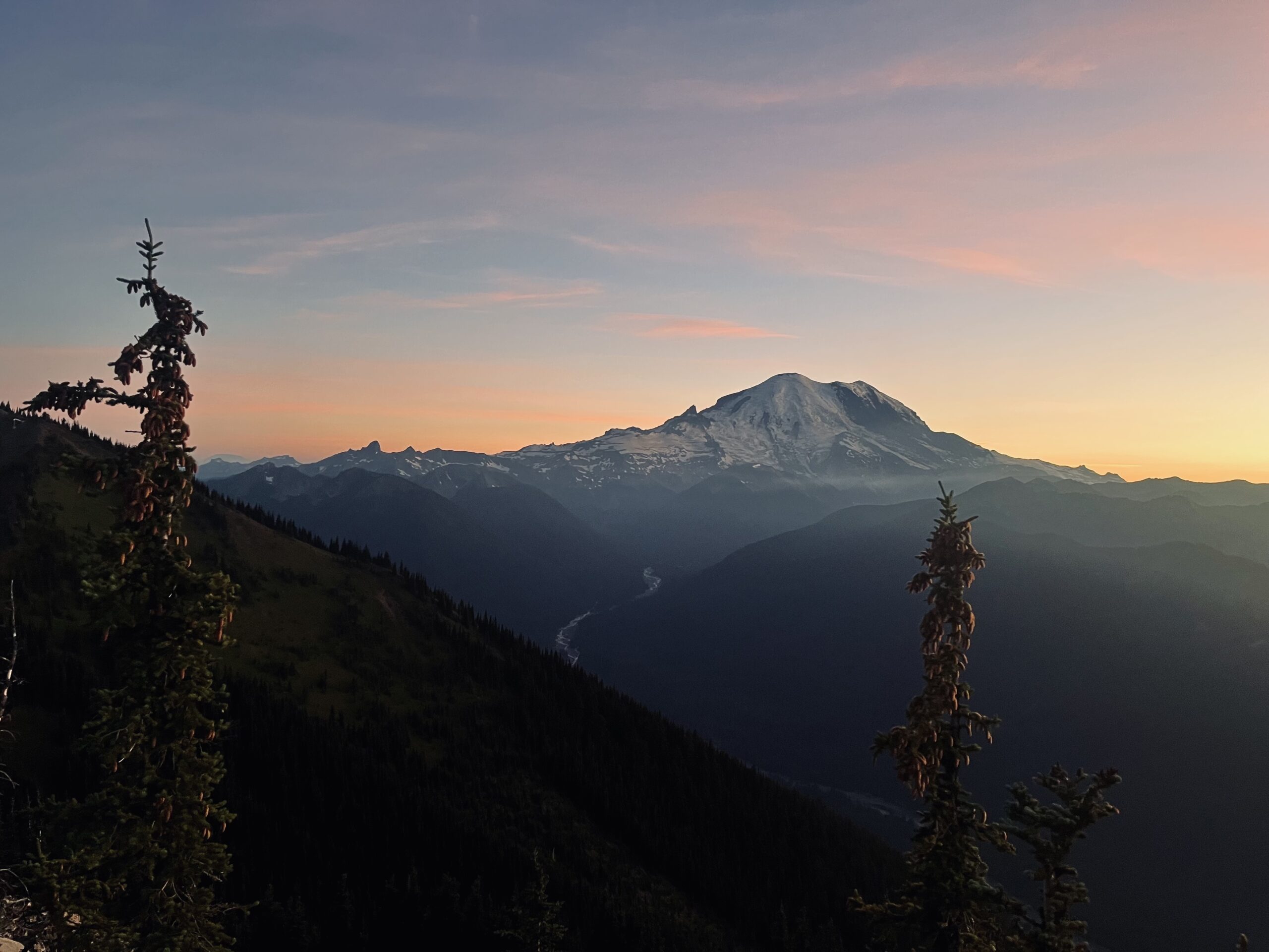 Mount Rainier glowing in the sunset as seen from the summit during Summit Fest 2025