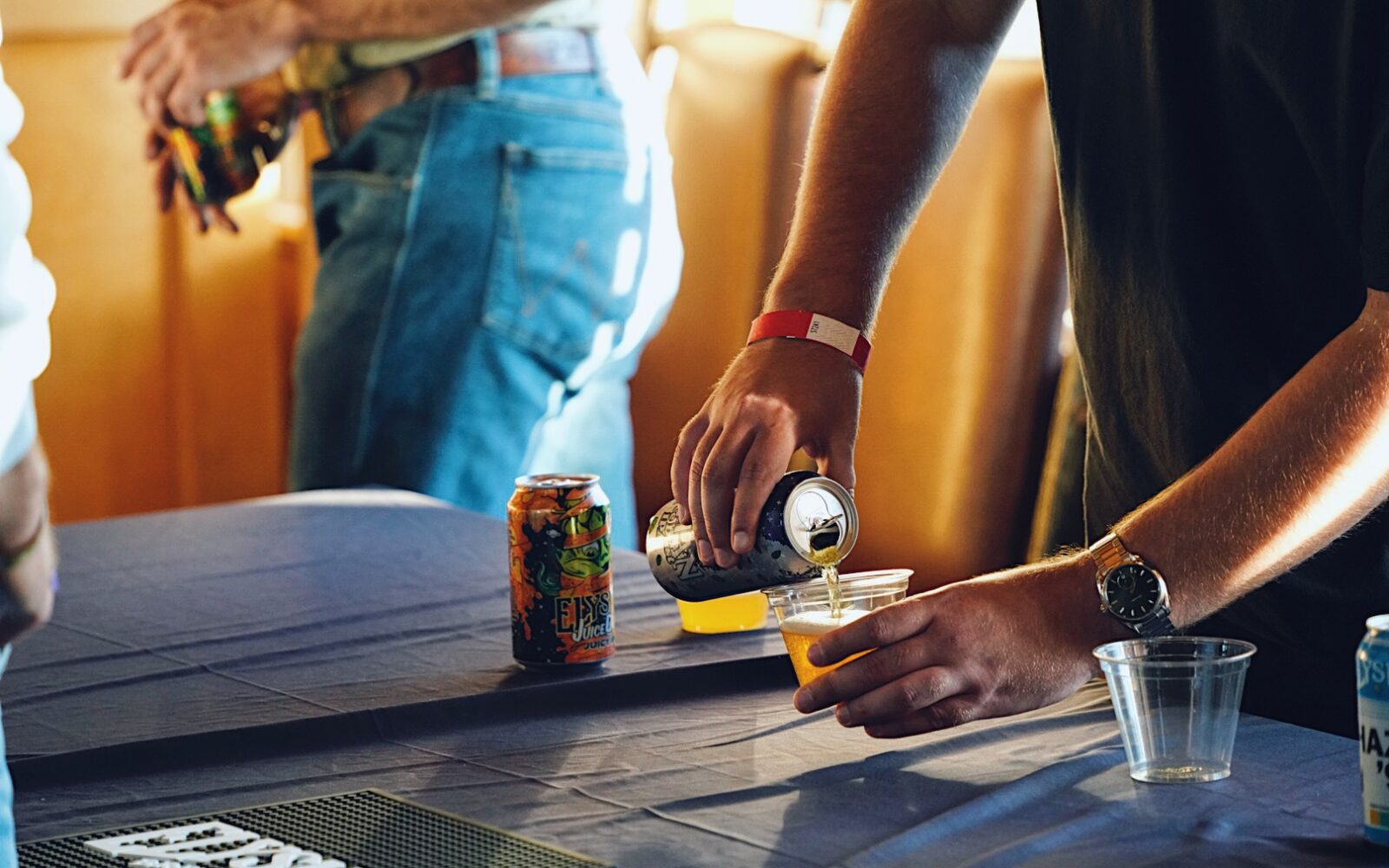 A man's hand pours a beer at Summit Fest.