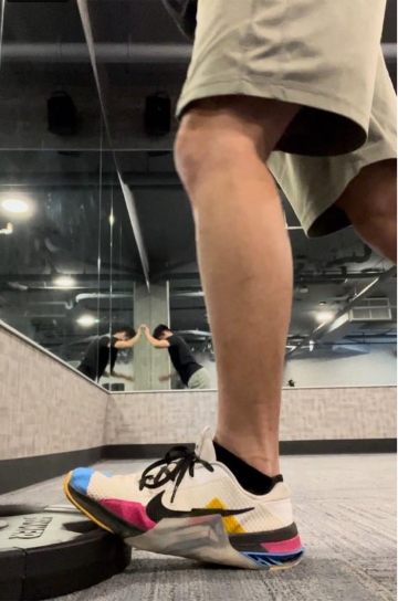 A person's legs in a mirror