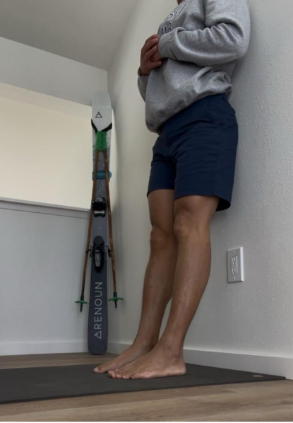 A person standing against a wall