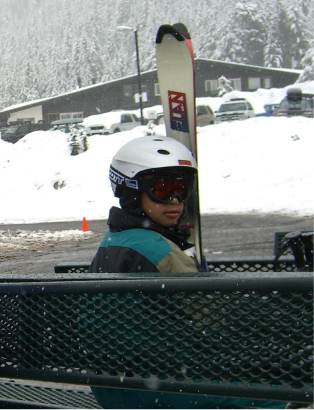 A person sitting on a bench with a ski