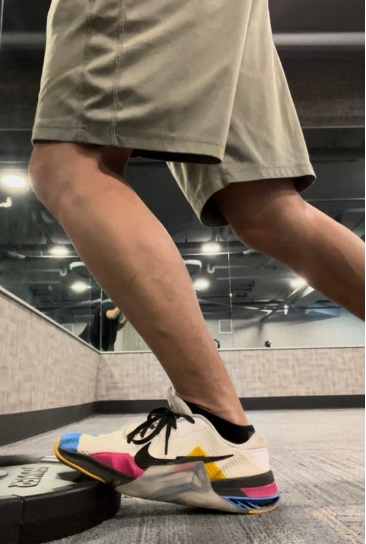 A person wearing shorts and running shoes