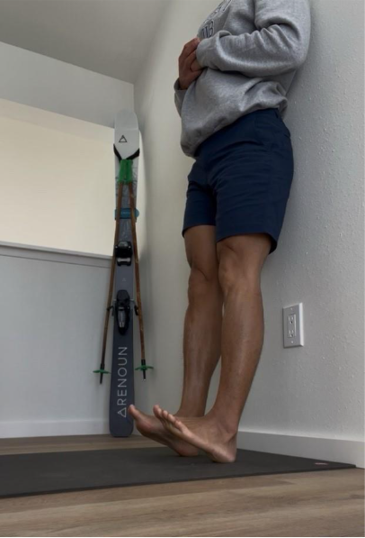 A person standing against a wall