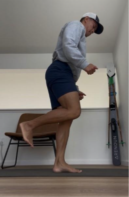 A person preparing for an RDL facing a wall