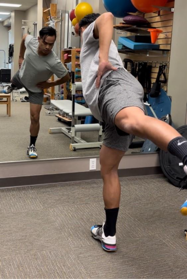 A person stretching in front of a mirror
