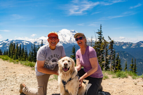 Couple with their dog and views of Mount Rainier in the background.