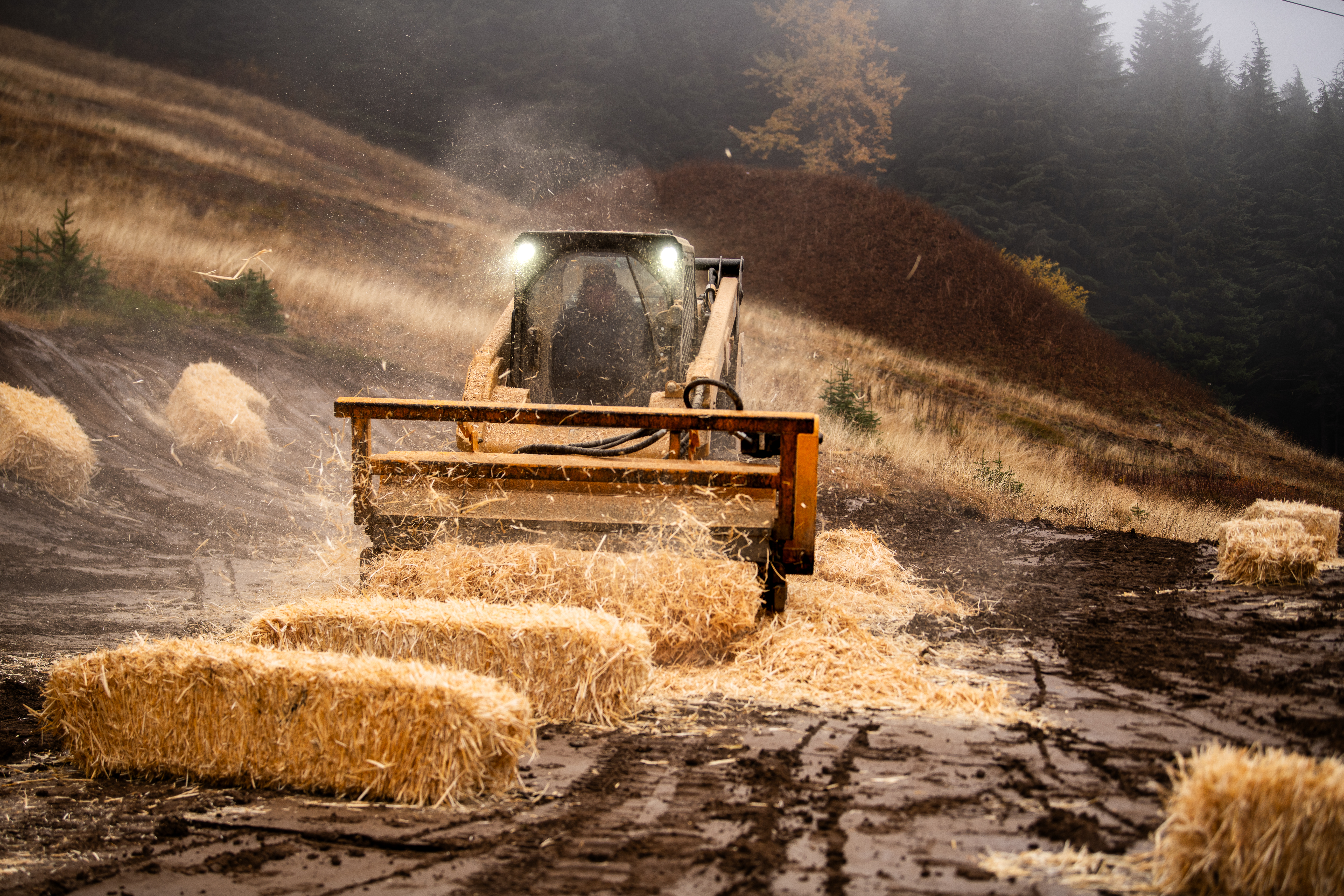 A wheat thresher cuts the way for a ski run.