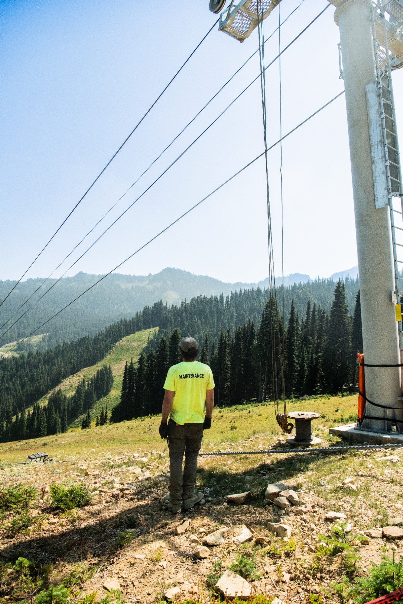 A lone worker stares out at the Cascades