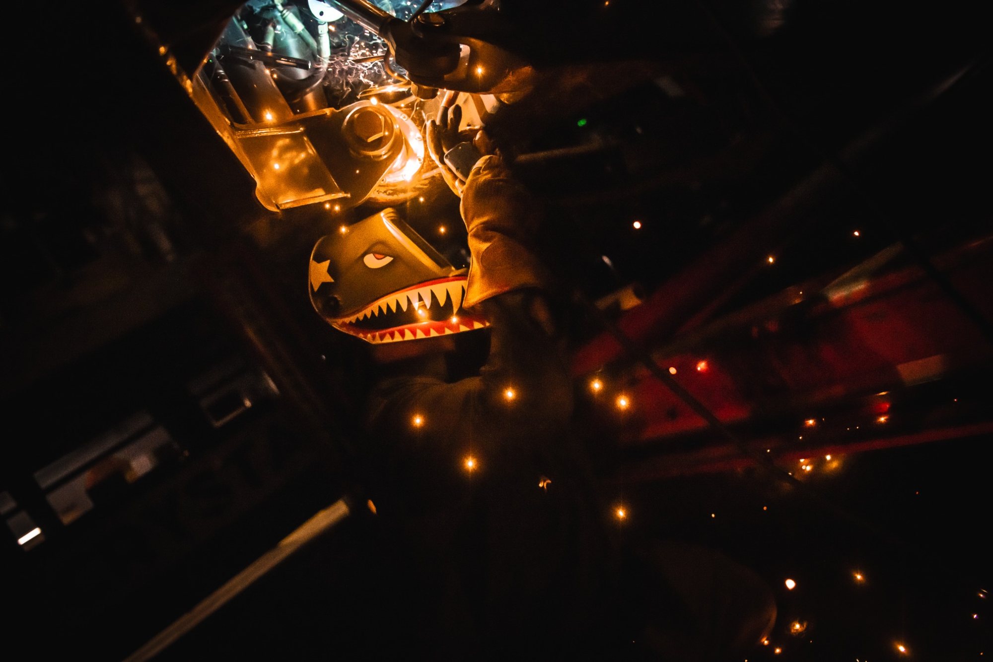 Worker in shark mask welds on a PistenBully